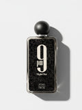 9 PM Night Out — black speckled bottle in a silver frame with a round matte cap, top-down