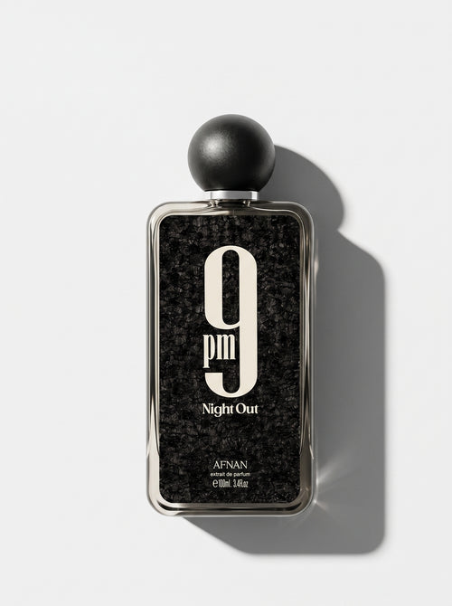 9 PM Night Out — black speckled bottle in a silver frame with a round matte cap, top-down