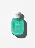 Hawas Tropical — emerald green glass bottle with a white rope-textured cap, shot top-down