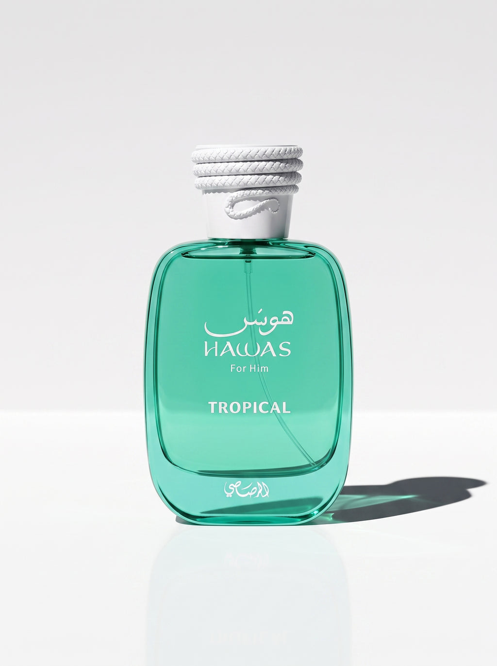 Hawas Tropical — the emerald bottle upright at eye level, white rope cap and TROPICAL label in view
