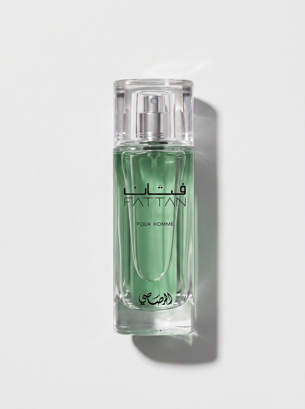 Rasasi Fattan — clear glass bottle of pale green juice with a clear cap, FATTAN Pour Homme, top-down