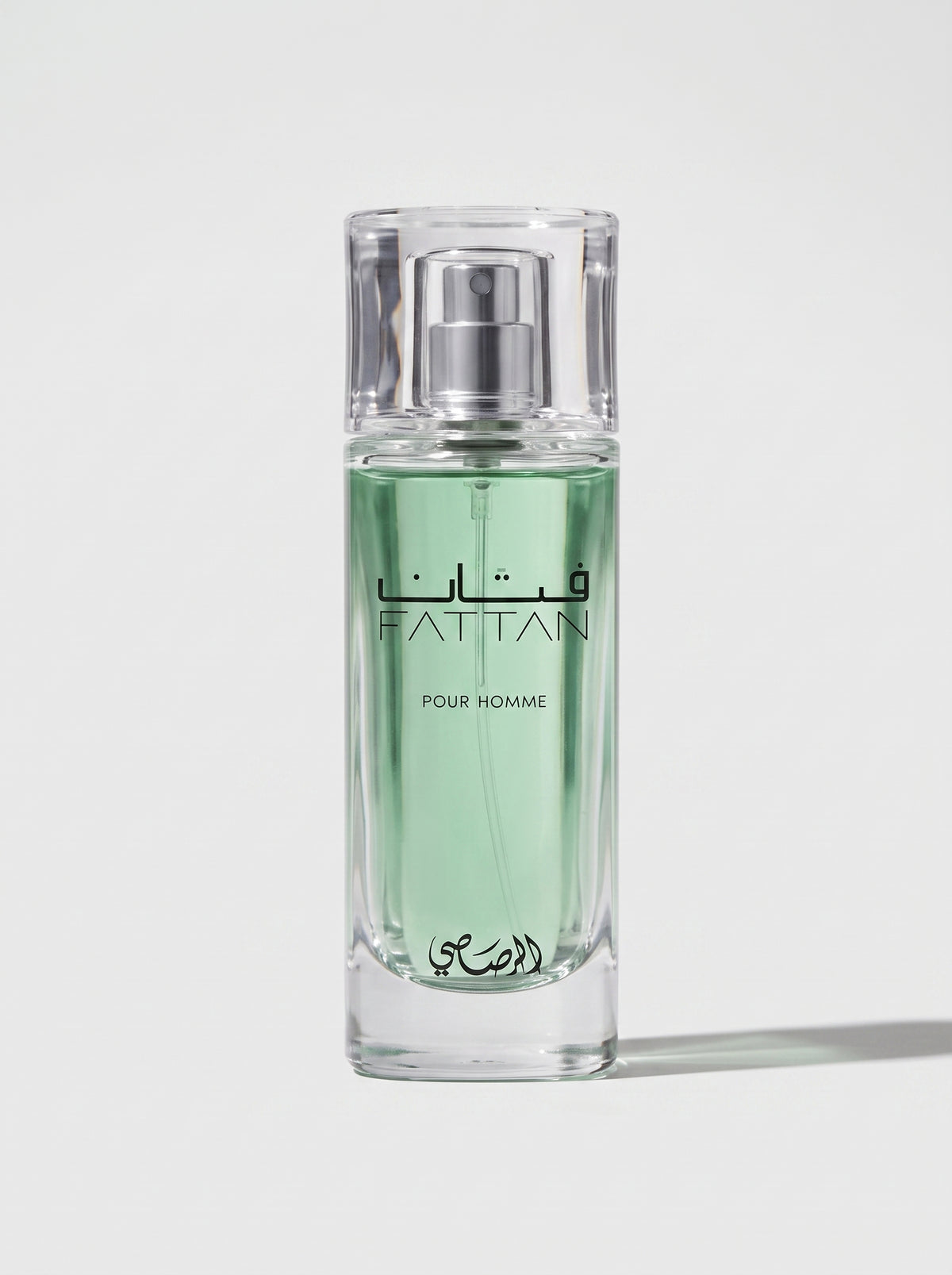Rasasi Fattan — the green-juice bottle upright at eye level, spray nozzle and FATTAN label in view