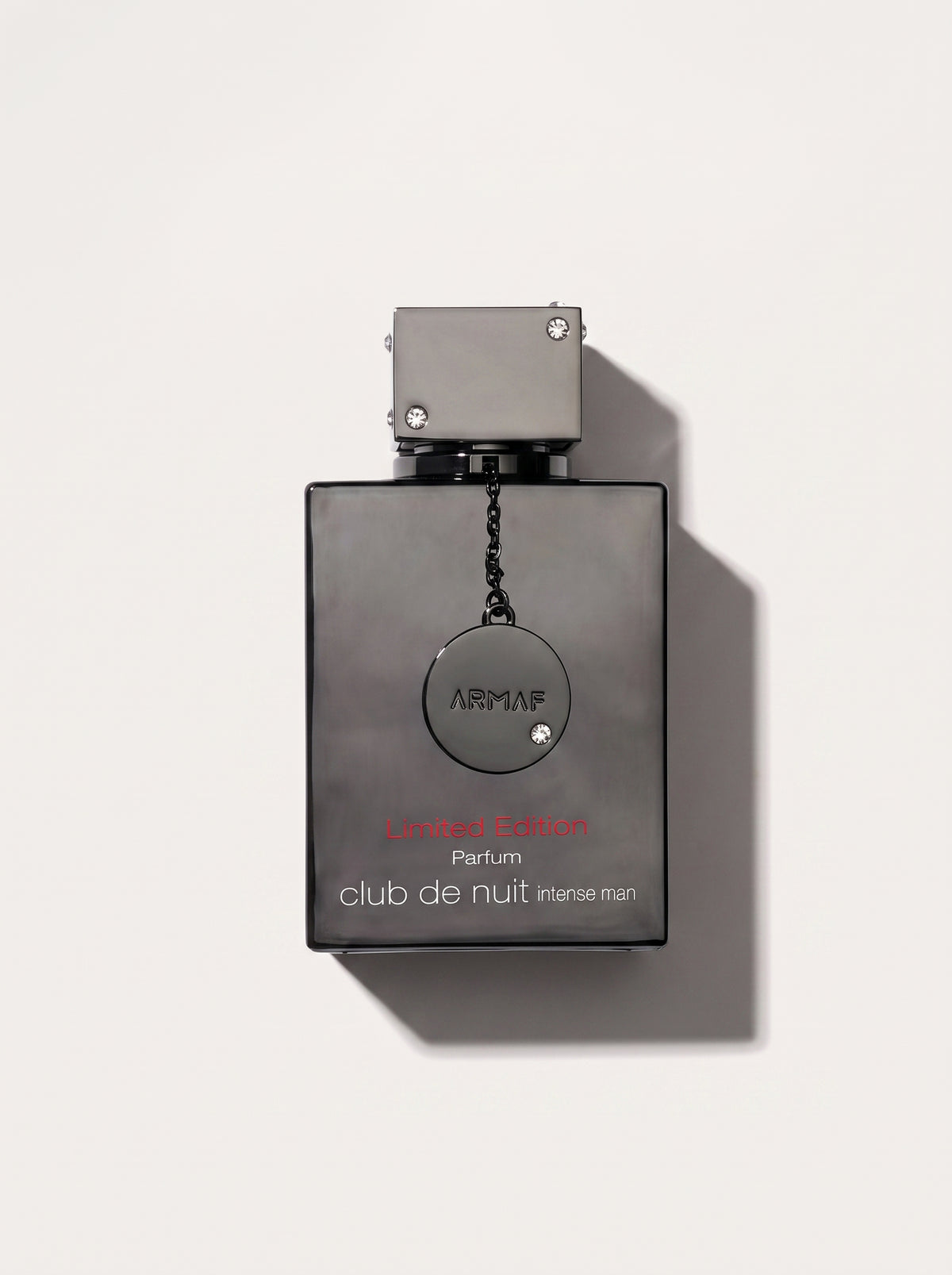 Club De Nuit Intense Man Limited Edition Parfum — black bottle, chained ARMAF medallion, red Arabic script, top-down
