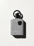 Supremacy Collector's Edition — grey speckled stone-effect bottle with a black crest and ring cap, top-down